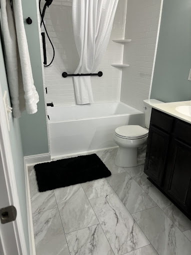 A bathroom with a toilet, sink, and bathtub